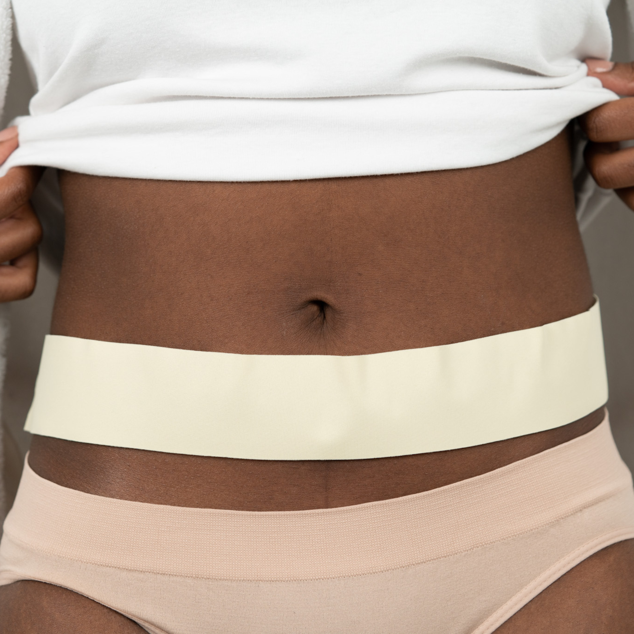 Advanced Medical-Grade Silicone 2" x 24" Roll applied on black women's stomach| beige